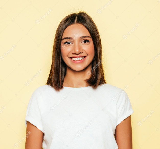 Young beautiful woman looking at camera. trendy girl in casual summer white t-shirt and jeans shorts. positive female shows facial emotions. funny model isolated on yellow Free Photo